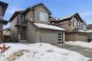 View of front of home featuring a garage and roof mounted solar panels - 9882 225A St Nw, Edmonton, AB  - Outdoor 