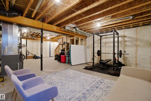 Unfinished below grade area with heating unit - 9882 225A St Nw, Edmonton, AB - Indoor Photo Showing Basement