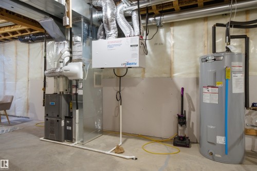 Utility room with electric water heater and heating unit - 9882 225A St Nw, Edmonton, AB - Indoor Photo Showing Basement