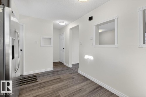 Corridor featuring a textured ceiling and wood finished floors - 133 Habitat Crescent, Edmonton, AB - Indoor Photo Showing Other Room
