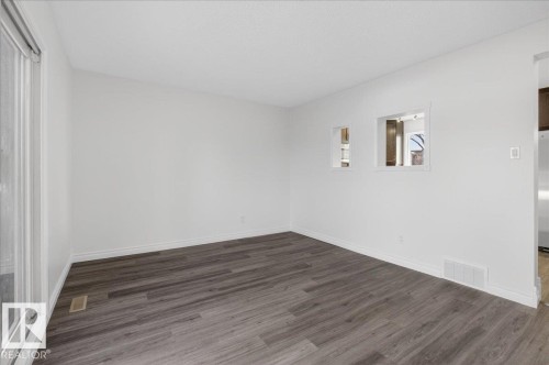 Unfurnished room with dark wood-style floors and baseboards - 133 Habitat Crescent, Edmonton, AB - Indoor Photo Showing Other Room