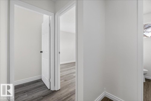 Hallway featuring baseboards and dark wood-style flooring - 133 Habitat Crescent, Edmonton, AB - Indoor Photo Showing Other Room