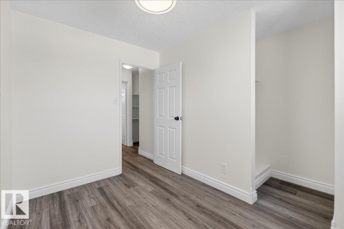 Unfurnished room featuring a textured ceiling and wood finished floors - 133 Habitat Crescent, Edmonton, AB - Indoor Photo Showing Other Room