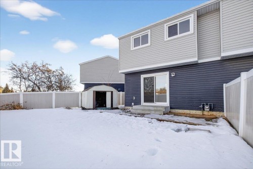 Snow covered rear of property with a shed and a fenced backyard - 133 Habitat Crescent, Edmonton, AB - Outdoor With Exterior