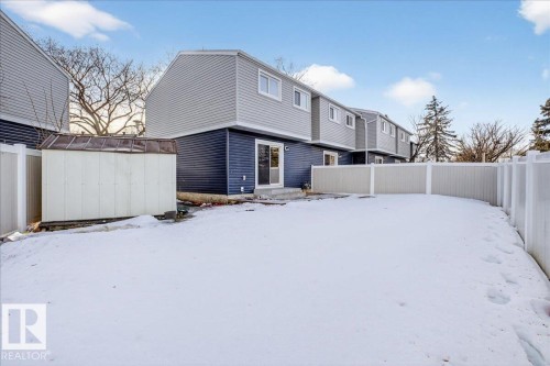 Snow covered house with a fenced backyard and a shed - 133 Habitat Crescent, Edmonton, AB - Outdoor