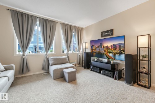 Living room featuring carpet flooring and baseboards - 91 603 Watt Boulevard, Edmonton, AB - Indoor