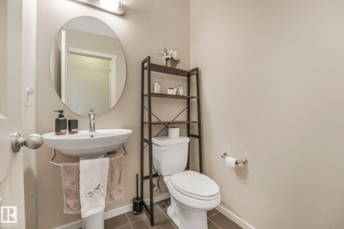Bathroom with toilet and dark tile patterned flooring - 91 603 Watt Boulevard, Edmonton, AB - Indoor Photo Showing Bathroom
