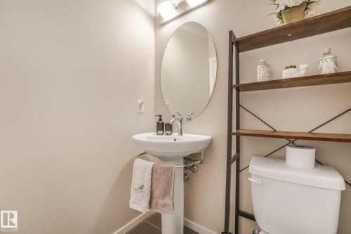 Half bath with toilet and baseboards - 91 603 Watt Boulevard, Edmonton, AB - Indoor Photo Showing Bathroom