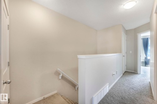 Corridor featuring an upstairs landing, carpet, and a textured ceiling - 91 603 Watt Boulevard, Edmonton, AB - Indoor Photo Showing Other Room
