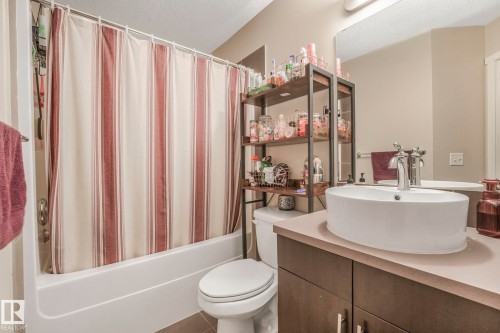 Bathroom with vanity, a textured ceiling, and shower / bath combo - 91 603 Watt Boulevard, Edmonton, AB - Indoor Photo Showing Bathroom
