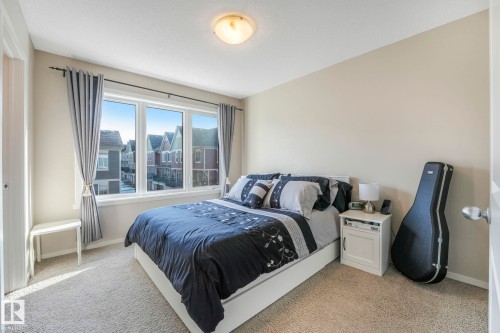 Bedroom with light carpet and baseboards - 91 603 Watt Boulevard, Edmonton, AB - Indoor Photo Showing Bedroom
