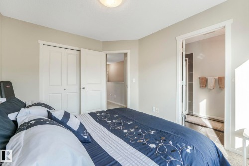 Carpeted bedroom featuring a closet and ensuite bathroom - 91 603 Watt Boulevard, Edmonton, AB - Indoor Photo Showing Bedroom