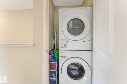 Laundry area featuring stacked washer and dryer - 91 603 Watt Boulevard, Edmonton, AB - Indoor Photo Showing Laundry Room