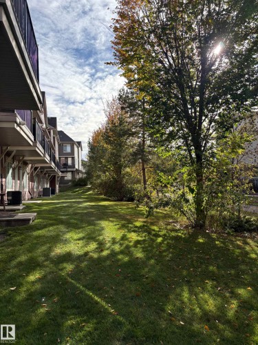 View of green lawn with a wooden deck - 91 603 Watt Boulevard, Edmonton, AB - Outdoor