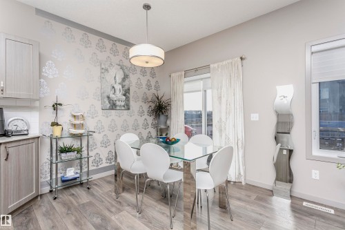 Dining area featuring light wood-style floors and baseboards - 2855 16 Avenue, Edmonton, AB - Indoor Photo Showing Dining Room