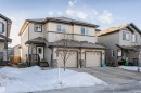 View of front of home with a garage, stone siding, driveway, and a shingled roof - 2855 16 Avenue, Edmonton, AB  - Outdoor With Facade 