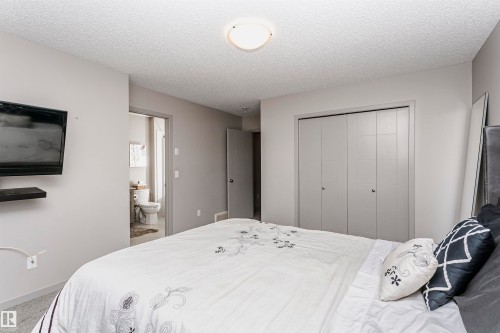 Bedroom with a textured ceiling and a closet - 2855 16 Avenue, Edmonton, AB - Indoor Photo Showing Bedroom