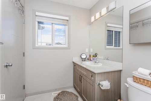 Bathroom with vanity, a textured ceiling, and light tile patterned floors - 2855 16 Avenue, Edmonton, AB - Indoor Photo Showing Bathroom