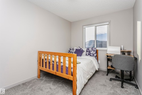 Bedroom featuring a textured ceiling and carpet floors - 2855 16 Avenue, Edmonton, AB - Indoor Photo Showing Bedroom