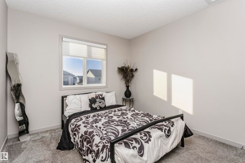 Bedroom with light colored carpet and a textured ceiling - 2855 16 Avenue, Edmonton, AB - Indoor Photo Showing Bedroom