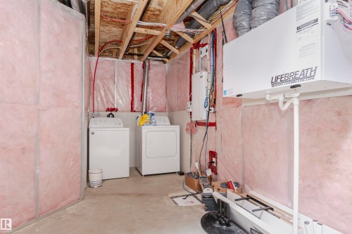 Unfinished below grade area with washer and dryer - 2855 16 Avenue, Edmonton, AB - Indoor Photo Showing Laundry Room