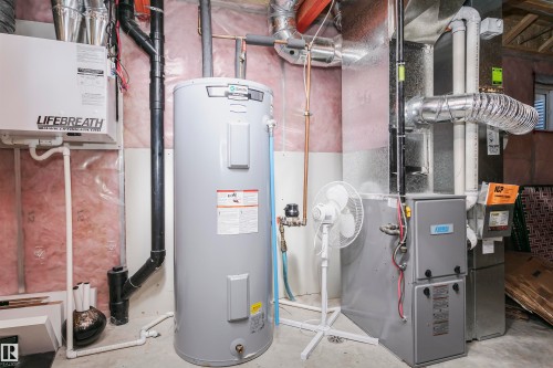 Utilities featuring water heater and heating unit - 2855 16 Avenue, Edmonton, AB - Indoor Photo Showing Basement