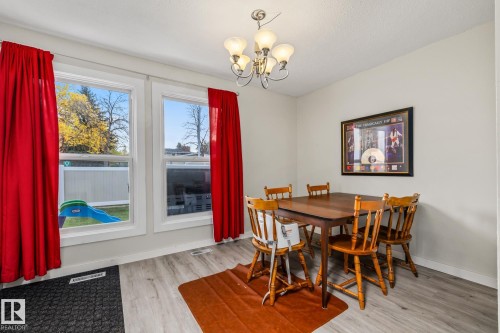 Dining room with light wood-style floors and suspended lighting - 11 Grandview Ridge, St. Albert, AB - Indoor Photo Showing Dining Room