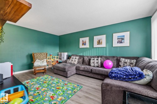 Living room with wood finished floors and a textured ceiling - 11 Grandview Ridge, St. Albert, AB - Indoor Photo Showing Living Room