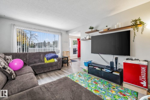 Living area featuring light wood-style flooring and a textured ceiling - 11 Grandview Ridge, St. Albert, AB - Indoor Photo Showing Living Room