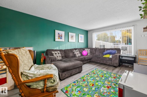 Living area featuring wood finished floors and a textured ceiling - 11 Grandview Ridge, St. Albert, AB - Indoor Photo Showing Living Room