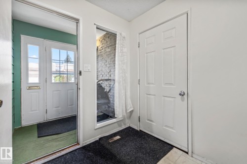 Entryway with a fireplace - 11 Grandview Ridge, St. Albert, AB - Indoor Photo Showing Other Room