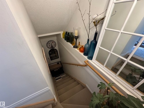 Carpeted bedroom with a textured ceiling - 208 178 Bridgeport Boulevard, Leduc, AB - Indoor Photo Showing Bedroom