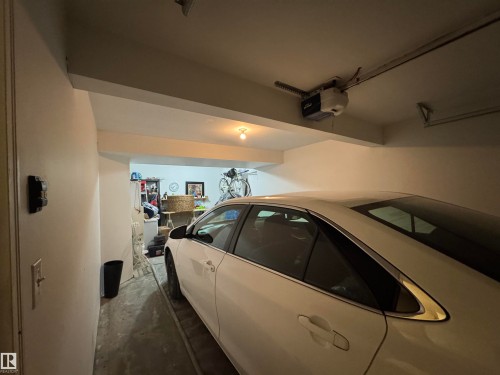 Basement Corridor featuring a textured ceiling and light tile patterned flooring - 208 178 Bridgeport Boulevard, Leduc, AB - Indoor