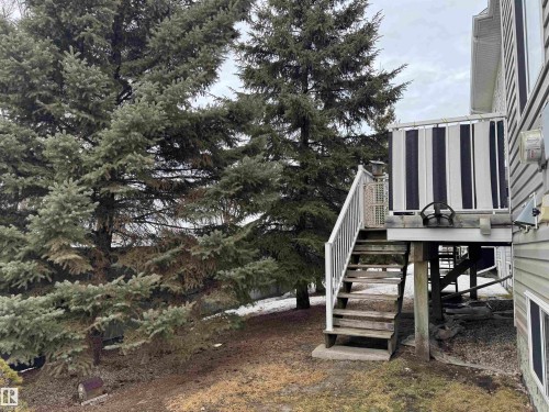 View of wooden steps going to yard beside Visitor parking - 208 178 Bridgeport Boulevard, Leduc, AB - Outdoor
