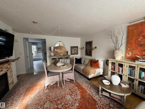 Living area with a textured ceiling. Front entry view as you walk up stairs - 208 178 Bridgeport Boulevard, Leduc, AB - Indoor