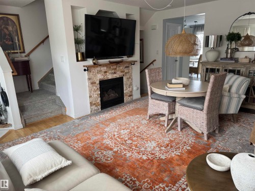 Staircase leading from basement up to the main floor featuring hanging lights - 208 178 Bridgeport Boulevard, Leduc, AB - Indoor Photo Showing Other Room