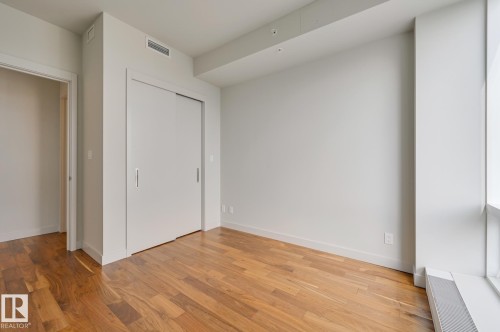 Unfurnished bedroom with a closet and light wood finished floors - 3704 10360 102 Street, Edmonton, AB - Indoor Photo Showing Other Room