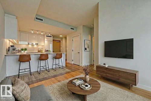 Living area with light wood-style flooring and baseboards - 3704 10360 102 Street, Edmonton, AB - Indoor Photo Showing Living Room