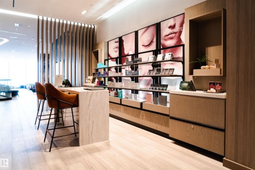 Bar area with floor to ceiling windows, open shelves, light stone counters, modern cabinets, and light wood finish cabinetry - 3704 10360 102 Street, Edmonton, AB - Indoor