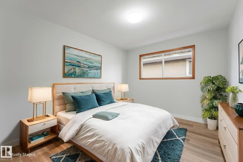 Bedroom with light wood-style flooring and baseboards - 6007 95 Avenue, Edmonton, AB - Indoor Photo Showing Bedroom