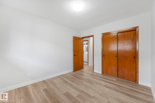 Unfurnished bedroom with light wood finished floors and a closet - 6007 95 Avenue, Edmonton, AB - Indoor Photo Showing Other Room
