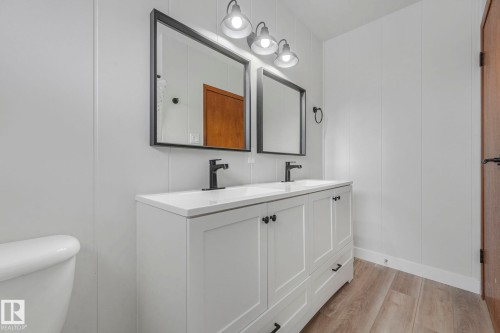 Bathroom with light wood-style floors and double vanity - 6007 95 Avenue, Edmonton, AB - Indoor Photo Showing Bathroom