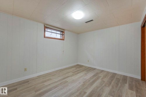 Basement featuring wood finished floors and wood walls - 6007 95 Avenue, Edmonton, AB - Indoor Photo Showing Other Room