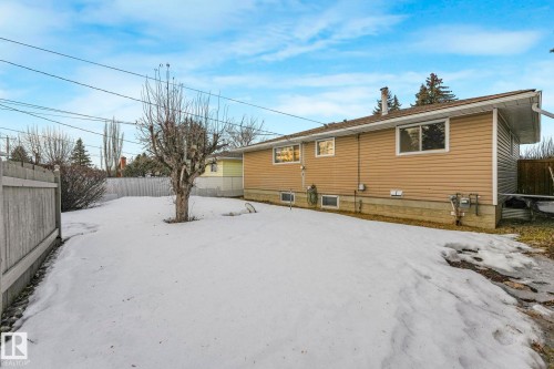 Snow covered property featuring a fenced backyard - 6007 95 Avenue, Edmonton, AB - Outdoor