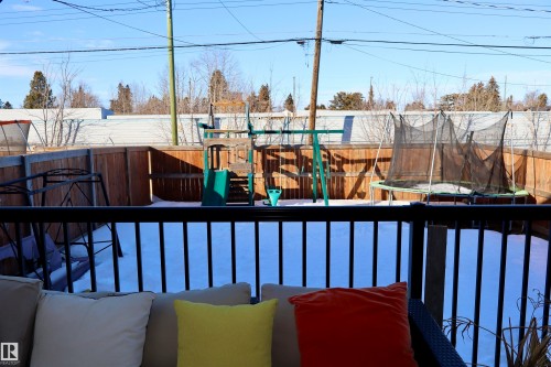 View of swimming pool with a trampoline, a fenced backyard, and a playground - 9760 - 107 Street, Westlock, AB - Outdoor