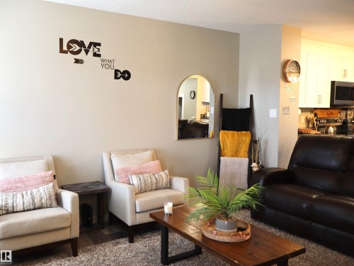 Living room featuring arched walkways and wood finished floors - 9760 - 107 Street, Westlock, AB - Indoor Photo Showing Living Room