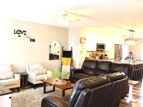 Living area featuring dark wood finished floors and a ceiling fan - 9760 - 107 Street, Westlock, AB - Indoor Photo Showing Living Room