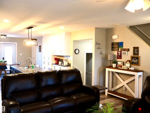 Living room with dark wood-style floors and recessed lighting - 9760 - 107 Street, Westlock, AB - Indoor