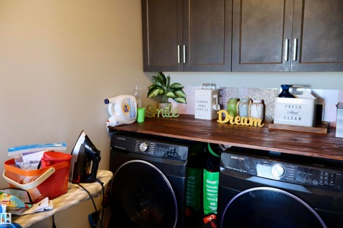 Laundry area featuring washer and dryer and cabinet space - 9760 - 107 Street, Westlock, AB - Indoor Photo Showing Laundry Room