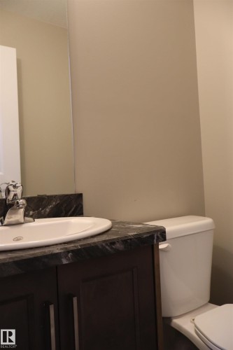 Half bath featuring vanity and toilet - 9760 - 107 Street, Westlock, AB - Indoor Photo Showing Bathroom